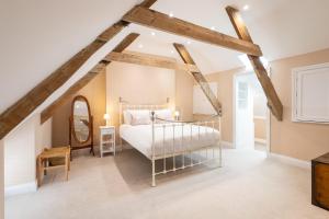 a bedroom with a bed and a mirror at Host & Stay - Hotspur Street in Alnwick