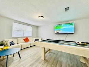 a living room with a pool table and a tv at Game Night Ready Lakeland Stay Near Colleges in Lakeland