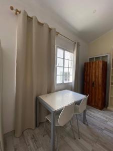 a table and two chairs in a room with a window at Casa Pavão in Pilar +49 photos