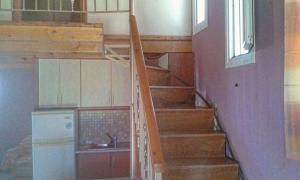 a staircase in a house with a kitchen and a sink at Ionian Balcony in Lixouri