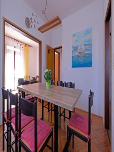 a dining room with a wooden table and chairs at Penthouse Stella in Pula +38 photos