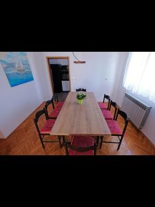 a dining room table with chairs and a bowl on it at Penthouse Stella in Pula