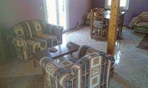a living room with two couches and a table at Ionian Balcony in Lixouri