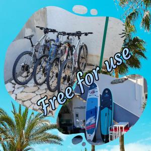 two bikes parked on a wall next to a surfboard at Laura's dream Appartments in Pag