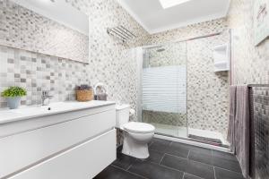 a bathroom with a toilet and a glass shower at La Lajita Barca Beach Palms in La Lajita +10 photos