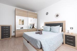 a bedroom with a large bed and a large mirror at La Lajita Barca Beach Palms in La Lajita