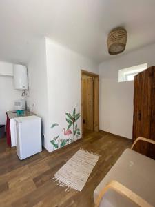 an empty living room with a kitchen and a table at Casa Pavão in Pilar