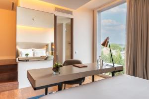 a room with a desk and a large window at Palácio do Governador - Lisbon Hotel & Spa in Lisbon