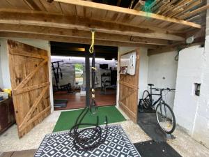 a bike parked in a garage with a gym at Domaine Du Tafiart in Sarron