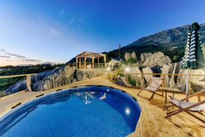 a swimming pool with a mountain in the background at Olive Hills Holiday homes 1 & 2 in Bar