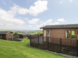 a house on a hill with a fence at Lodge 16 in Torpoint