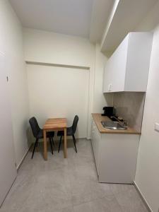 a small kitchen with a table and a sink at DATRI Petite Suite 6 in Vienna