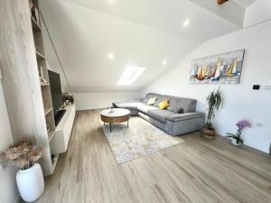 a living room with a couch and a table at Green View Apartment in Vrh