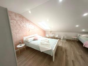 a bedroom with two beds and tables in it at Green View Apartment in Vrh