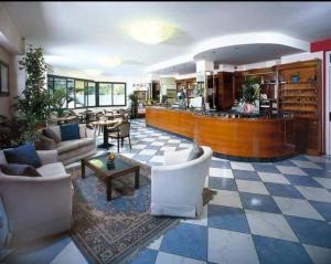 a living room with a lobby with a bar at Depandance Hotel President in Cesenatico