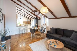 a living room with a couch and a table at Holiday home Coastal Soul in Mali Ston in Mali Ston