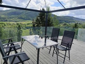 a table and chairs on a deck with a view at Holiday home in Steinkjer in Steinkjer
