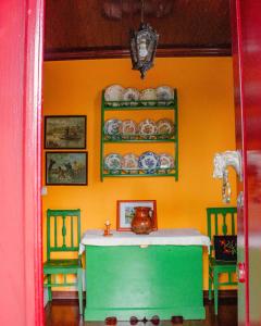 a dining room with a table and two chairs at Casa das Fontes in Ponte da Barca