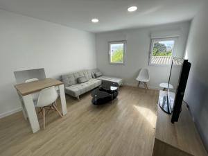 a living room with a couch and a table at Céntrico apartamento muralla 1 in Lugo