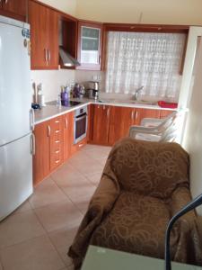 a kitchen with a chair and a refrigerator at Katerina house in Akritokhórion