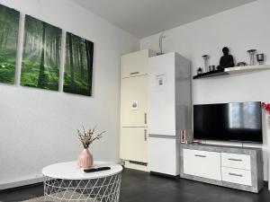a living room with a tv and a table at Sivas Ferienwohnung 2 in Ravensburg