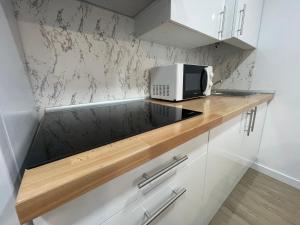 a microwave on a counter in a kitchen at Céntrico apartamento muralla 1 in Lugo +11 photos