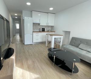 a living room with a couch and a table at Céntrico apartamento muralla 1 in Lugo +13 photos