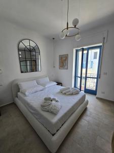 Rúm í herbergi á Terra Muronis Hotel Diffuso