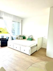 a bedroom with a white bed and a large window at Julia's apartment in Marbella +16 photos