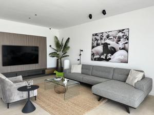 a living room with a couch and a tv at Luxury villa del Sol in Novalja