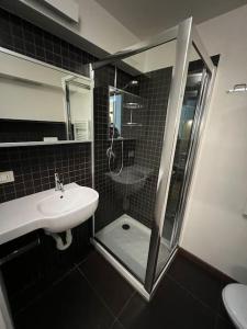 a bathroom with a shower and a sink and a shower at Appartamento in mezzo al verde in Sauze dʼOulx