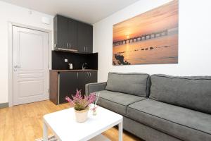 a living room with a couch and a table at Fetingas in Šventoji