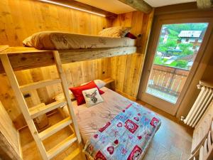 a room with two bunk beds and a window at Casa Clus Bormio apartments 2 in Valdisotto