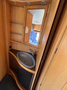 a bathroom with a sink and a mirror at Przyczepy kempingowe Nad Zatoką in Swarzewo +73 photos