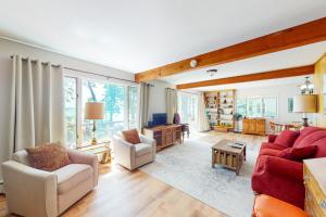 a living room with two couches and a table at Smith Family Cottages- Lake House in Indian River