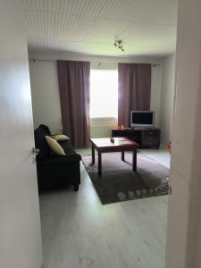 a living room with a couch and a coffee table at Oravamökki in Sotkajärvi