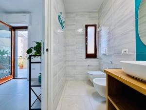 a bathroom with two toilets and a sink at YourHome - Blu Jade House in Piano di Sorrento