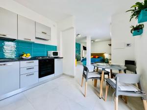a kitchen and dining room with a table and chairs at YourHome - Blu Jade House in Piano di Sorrento +9 photos