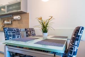 a table and chairs with a potted plant on it at Flexible SelfCheckIns 85 - Zagreb - Loggia - New in Zagreb