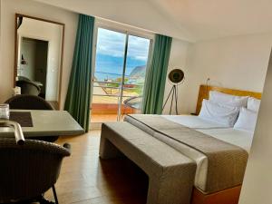 sypialnia z łóżkiem i oknem z widokiem w obiekcie Boutique Hotel Jardim Do Mar w mieście Jardim do Mar