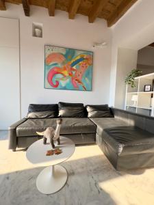 a living room with a couch and a table at Casa sulle mura Romane - Old town in Bergamo