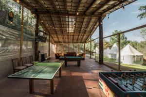 an outdoor entertaining area with ping pong tables at Exclusivo glamping en el bosque in Ferrería de Tula