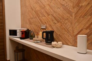a counter top with a coffee maker and a microwave at Antico Palazzo in Salerno