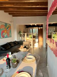 a living room with a table and a couch at Casa sulle mura Romane - Old town in Bergamo