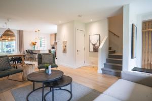 a living room with a couch and a table at Condos Kamik Tremblant by Manitonga in Mont-Tremblant