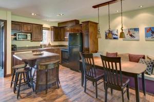 a kitchen with a table and chairs and a refrigerator at Tremblant Classic Chalet La Bête Golf Course in Mont-Tremblant
