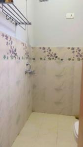 a bathroom with a shower with a toilet and a sink at The apricot house in Leh