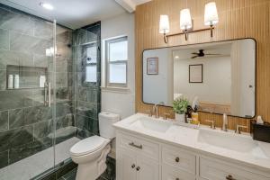 a bathroom with a shower and a toilet and a sink at Lakefront Granbury Home with Patio, Fire Pit and Dock! in Granbury +23 photos