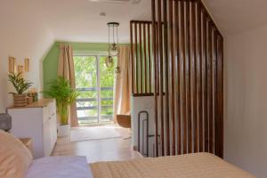 a bedroom with a bed and a large sliding door at Nyárfás Panoráma Vendégház in Dunavarsány