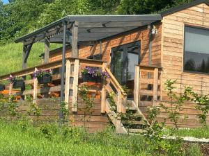 a log cabin with a porch and a roof at Na Rose in Terchová +1 photo